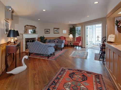 a living room with a swan on the floor at Mill Falls Resort Collection at the Lake in Meredith