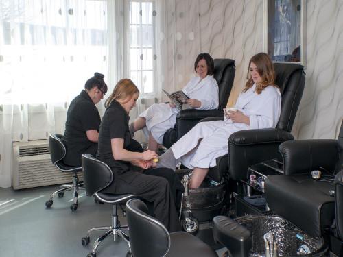 a group of people sitting in chairs in a salon at Mill Falls Resort Collection at the Lake in Meredith