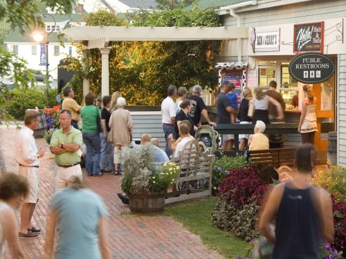 a crowd of people standing outside of a restaurant at Mill Falls Resort Collection at the Lake in Meredith
