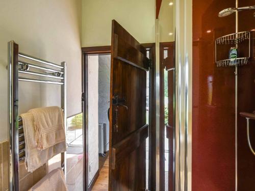 a bathroom with a shower and a glass door at The Old Barn in Hope Bowdler