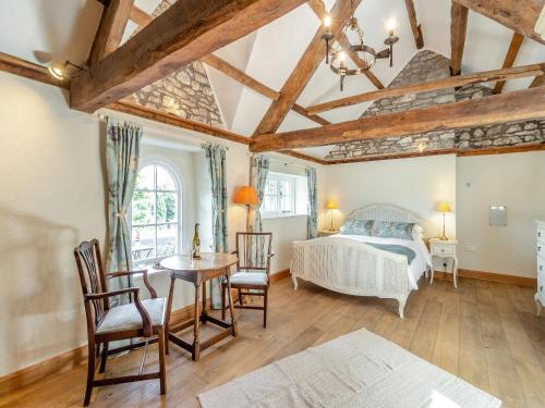 a bedroom with a bed and a table and chairs at The Chapel - Uk45026 in Gilwern