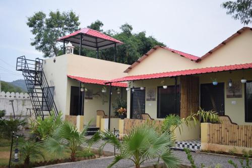 a house with a tower on top of it at Rann Meadows Ranthambhore in Sawāi Mādhopur