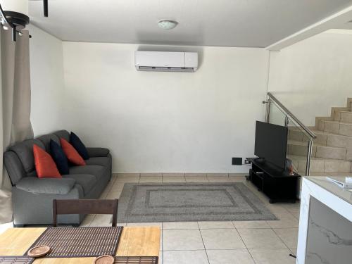 a living room with a couch and a television at Comfortable and roomy, in Sonsonate in Sonsonate