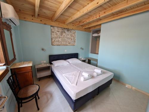 a bedroom with a bed and a table and a chair at Christos Katerina House in Pythagoreio