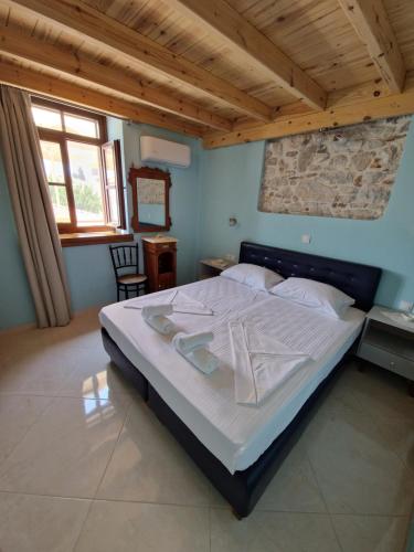 a bedroom with a large bed in a room at Christos Katerina House in Pythagoreio