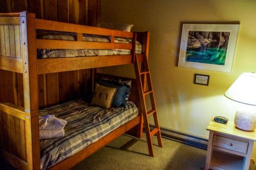 a bedroom with two bunk beds in a room at #278 Ski-in, Ski-out Corner unit with View in Mammoth Lakes