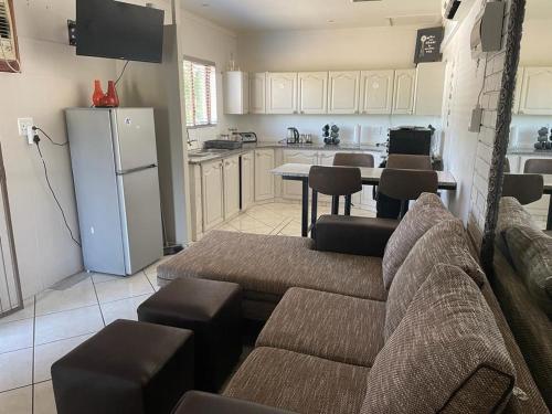 a living room with a couch and a kitchen at Beytell's Nest in Richards Bay