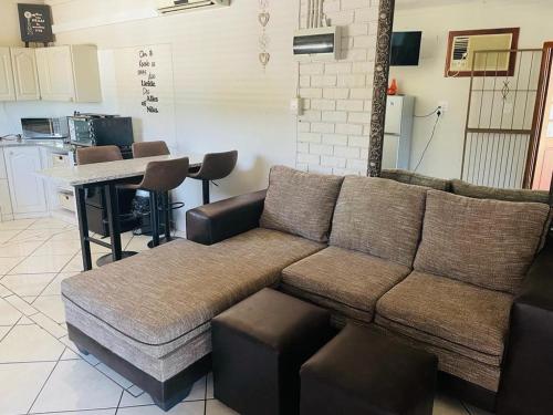 a living room with a couch and a table at Beytell's Nest in Richards Bay