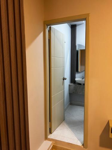a bathroom with a mirror and a shower door at HOTEl LA CANDELARIA ROOM HOUSE in Mangue