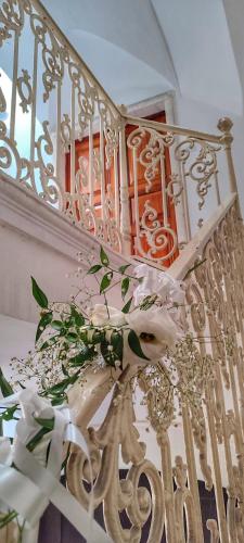 a white staircase with a bunch of flowers on it at Dimora della Marchesa - al Duomo in Manfredonia