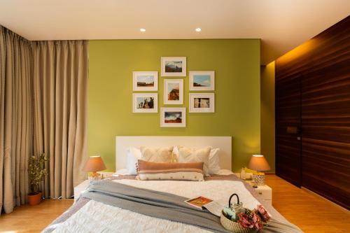 um quarto com uma cama grande e paredes verdes em Elivaas Dahlia Luxe 4BHK Villa with Pvt Pool near Baga em Arpora