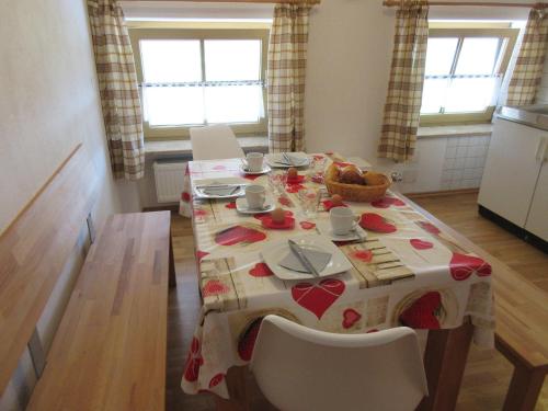 a dining room table with a red and white table cloth at Geppingerhof in Waging am See