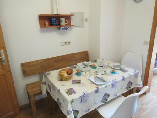 a table with a white table cloth and a basket of food at Geppingerhof in Waging am See