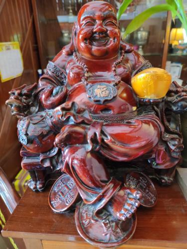 a red bear statue sitting on a table at U Dara inn in Siem Reap