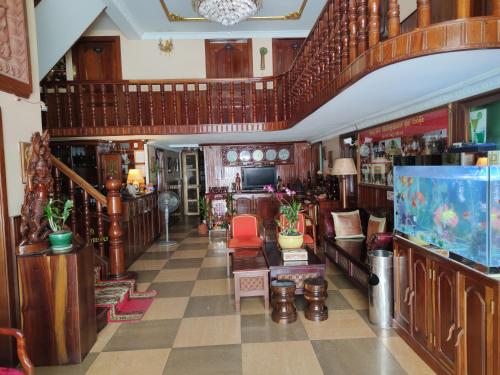 a living room with wooden floors and a large room at U Dara inn in Siem Reap