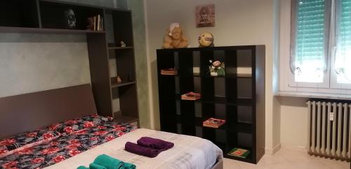 a bedroom with a bed and a book shelf at vercelli holiday house in Turin