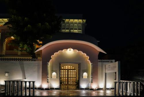 a building with a gold door in front of it at night at Dev Mahal - A Boutique Heritage Hotel in Jaipur