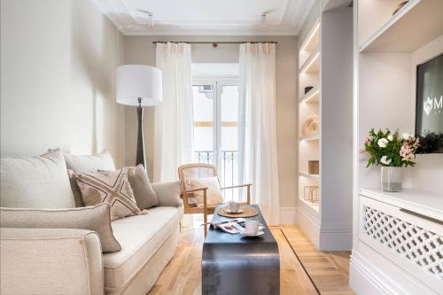 a living room with a couch and a table at Magno Apartments Casa Pilatos in Seville