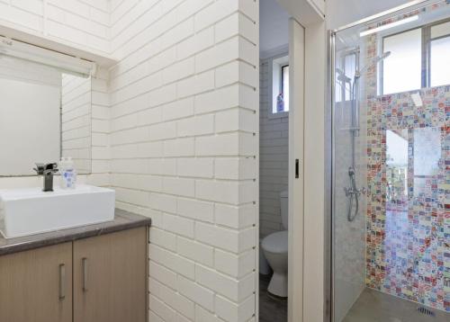 a bathroom with a toilet and a sink and a shower at Dreamy Nature Getaway in Rhyll