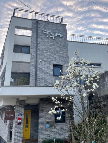 a building with a sign on the side of it at Guest House Dalggume in Mokpo