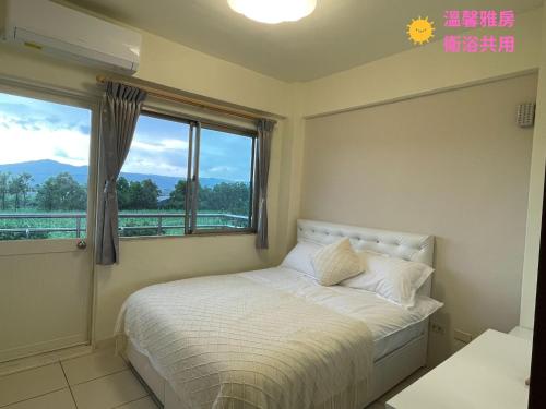 a bedroom with a bed and a large window at 埔里北梅民宿BEI MEI Homestay可包棟 in Puli