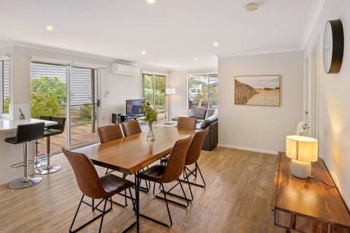 a dining room and living room with a table and chairs at Viente @ Cape Villas Dunsborough in Dunsborough