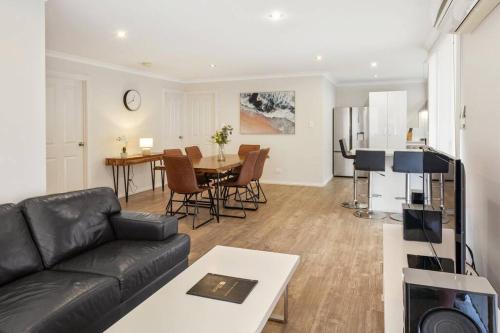 a living room with a couch and a table at Viente @ Cape Villas Dunsborough in Dunsborough