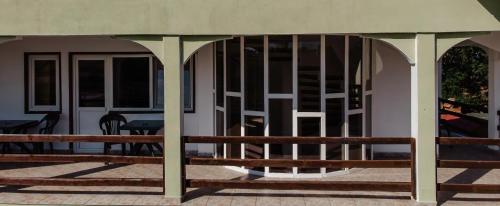 a porch with a wooden bench in front of a building at Pensiunea Victoria Sambata de Sus in Sîmbăta de Sus