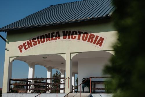 a building with a sign that reads rutherford voglia at Pensiunea Victoria Sambata de Sus in Sîmbăta de Sus