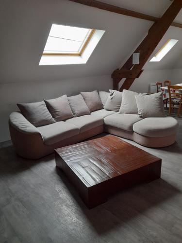 a living room with a couch and a coffee table at Gite esprit loft in Fromelles