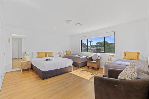 a living room with a bed and a couch at Lemon Tree Passage Motel in Lemon Tree Passage