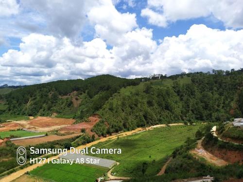 an aerial view of a green hill with trees at Tuyên Chiến Home & Resort in Ấp An Kroët