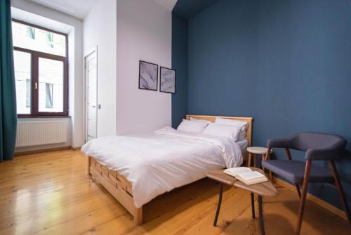 a bedroom with a bed and a table and a chair at City guli Brosse in Tbilisi City