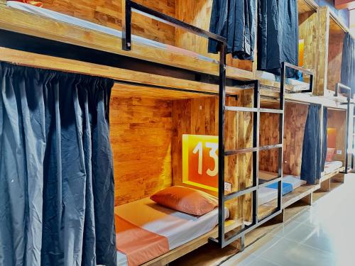 a bedroom with bunk beds in a wooden cabin at THE PLACE Hostel & Rooftop Bar in Battambang