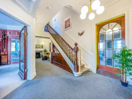 a hallway with a staircase in a house at *RD9bC* For your most relaxed & Cosy stay + Free Parking + Free Fast WiFi * in Moortown