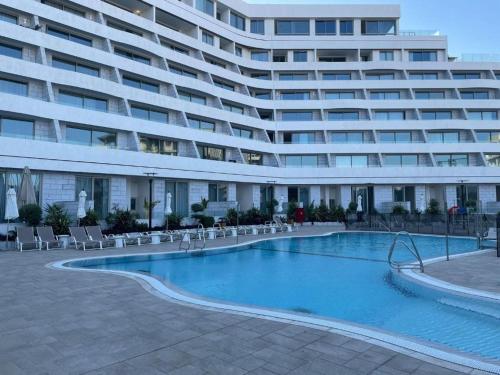 a large apartment building with a large swimming pool at Sea Side 92 Eilat סיסייד 92 אילת in Eilat