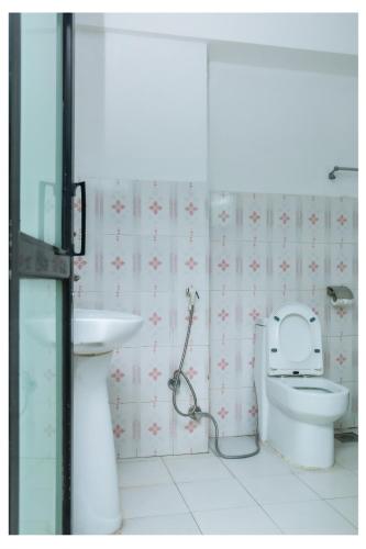 a bathroom with a toilet and a sink at Yaksa Hotel Pvt. Ltd. in Kathmandu