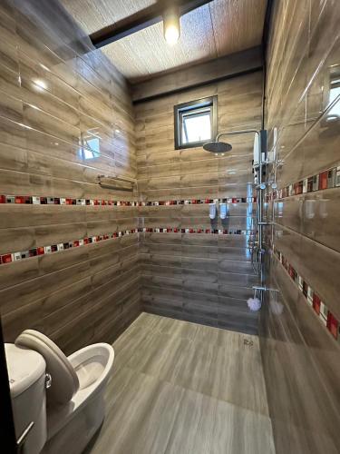 a bathroom with a shower with a toilet in it at The Nack Resort & Pool Villa บางบัวทอง in Nonthaburi