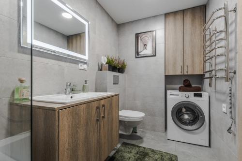 a bathroom with a sink and a washing machine at Home sweet Home in Vilnius