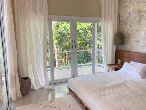 Ένα ή περισσότερα κρεβάτια σε δωμάτιο στο Eco- Seaview Casa - Wee Ra