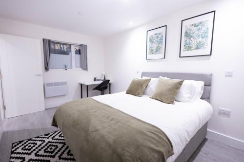 a white bedroom with a large bed and a window at Chic City Living - Luxury Apartment in London in Hemel Hempstead