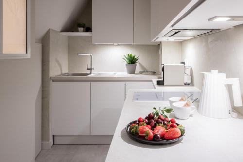 a bowl of fruit on a counter in a kitchen at Loveroom Muse old town jacuzzi Annecy vieille ville in Annecy