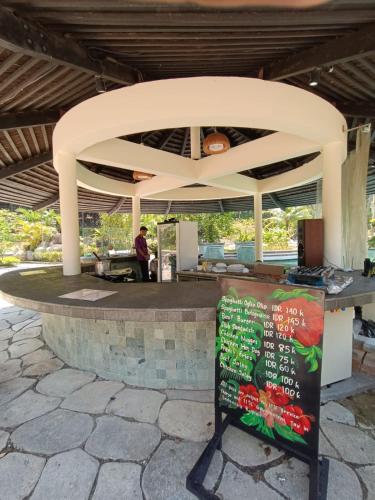 a food stand with a sign in front of it at Nongsa Village in Nongsa