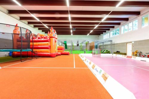 an indoor tennis court with an inflatable at Sunstar Hotel Arosa in Arosa
