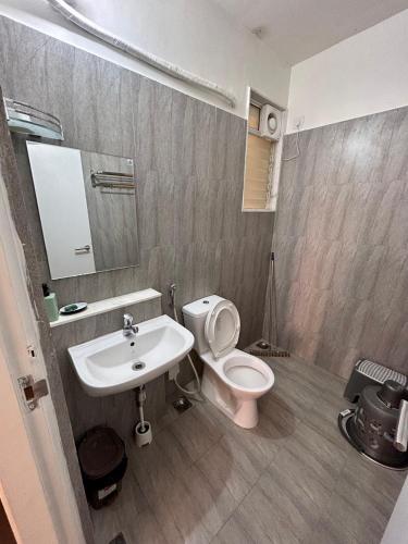 a bathroom with a white toilet and a sink at Good Stay Pool view stylish Studio Apartment,6km from Airport, 307 in Dabolim