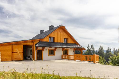 a large wooden house with a gambrel roof at Wellness Chalupa Benešky in Vsetín