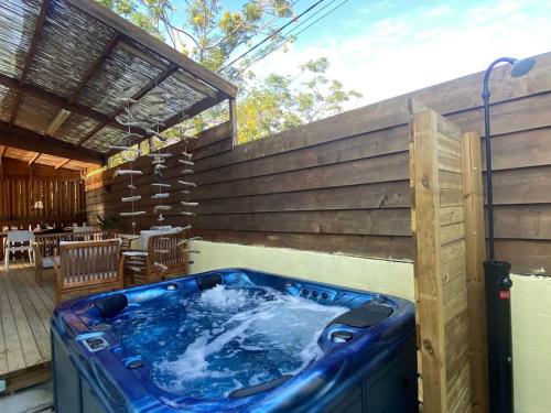 a large blue tub sitting on the side of a patio at Villa Albizia 974 avec piscine et spa in Saint-Pierre