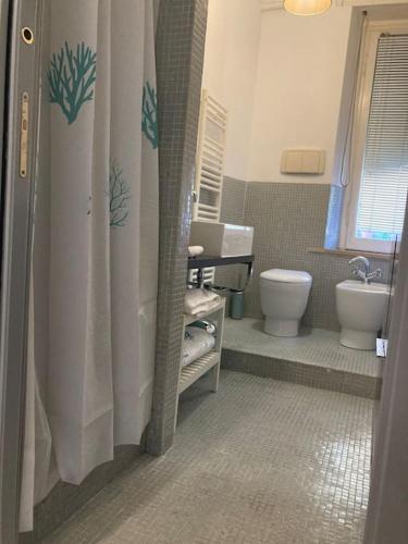 a bathroom with a shower and a toilet and a sink at Casa Olimpia in Terni