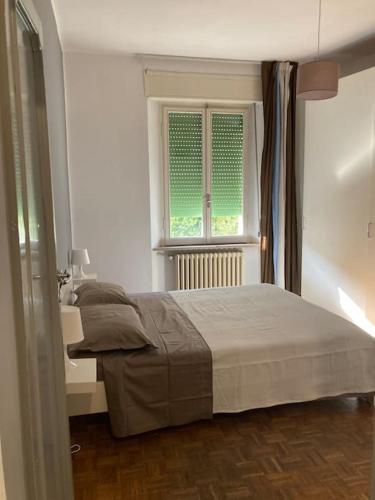 a bedroom with a bed and a window at Casa Olimpia in Terni