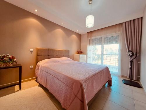 a bedroom with a large bed and a window at Agora Paradise in Side